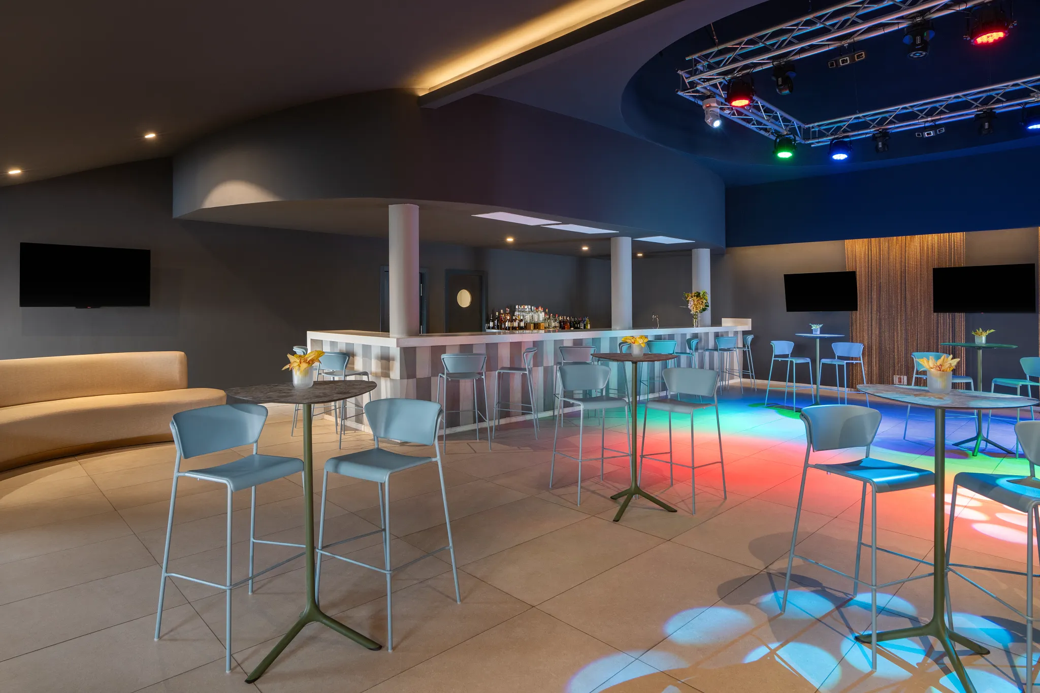 Desires sports bar and nightclub at Dreams Flora Resort & Spa featuring modern lounge seating, illuminated dance floor, and stylish bar area.