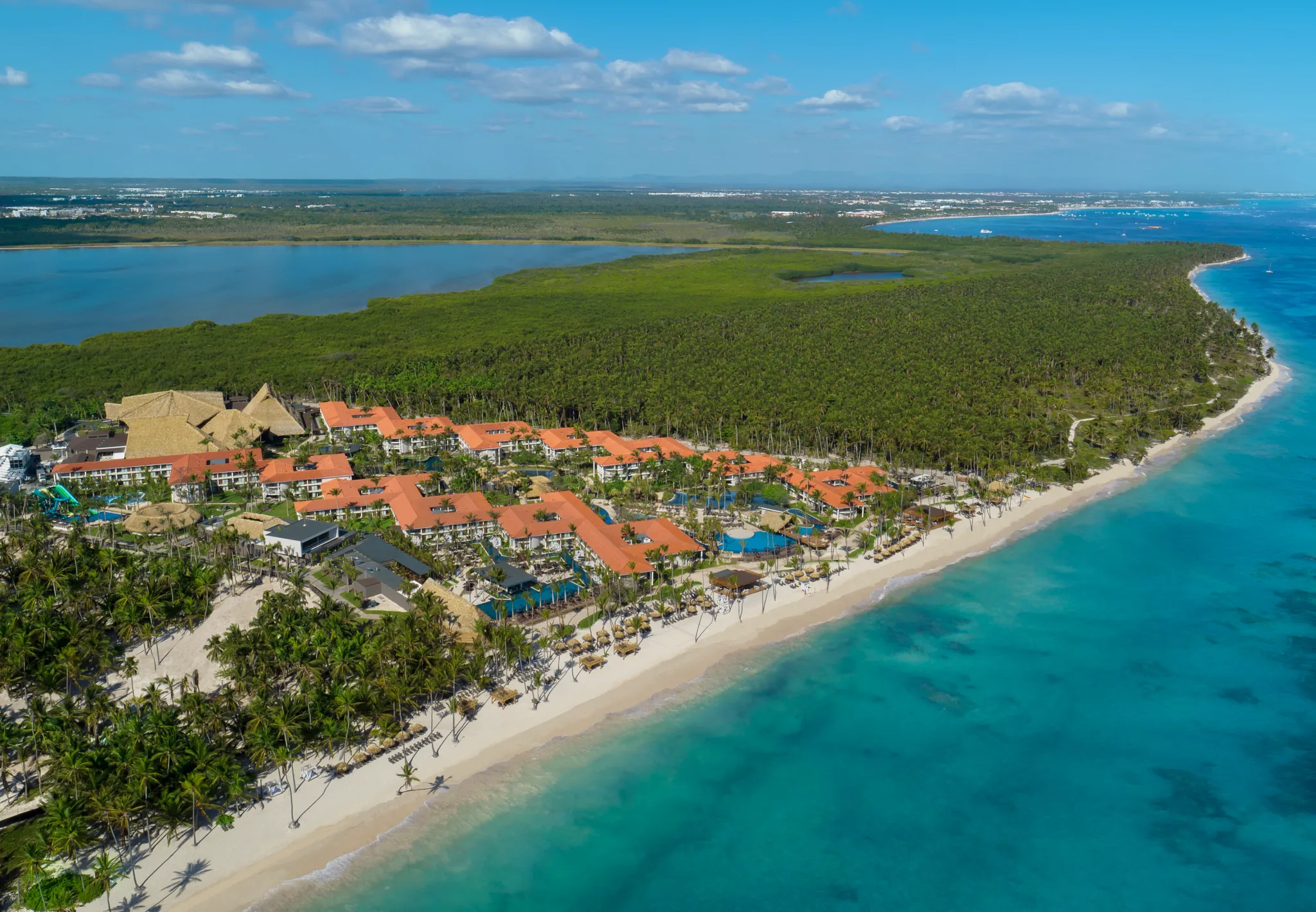 Aerial coastline view of Dreams Flora Resort & Spa with turquoise Caribbean waters and palm-lined beach.