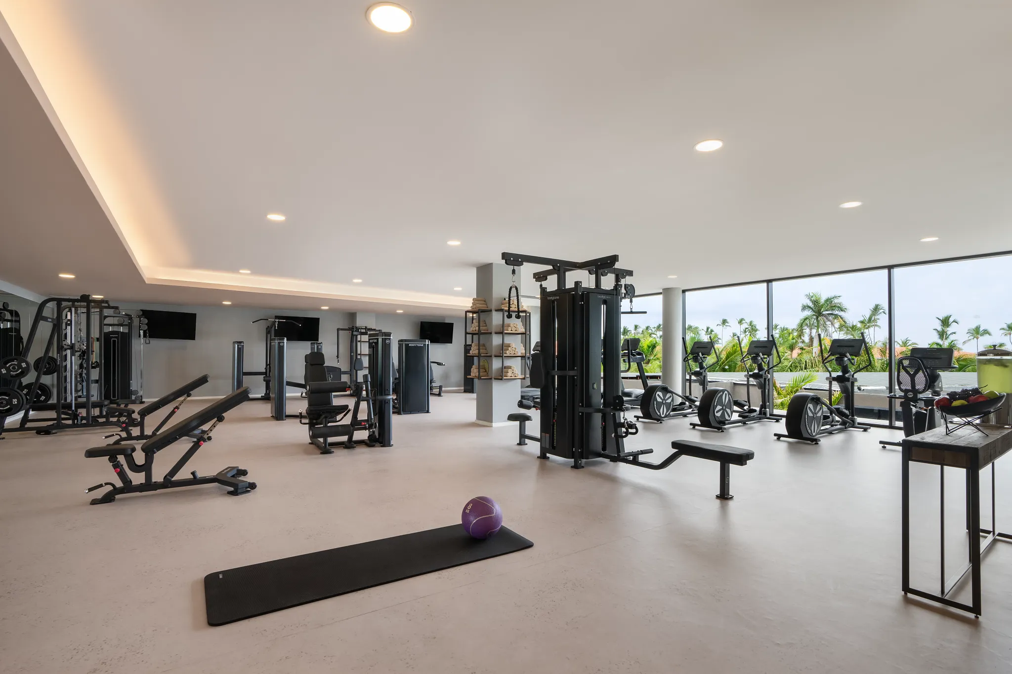 Modern fitness center with cardio machines and weights at Dreams Flora Resort & Spa Punta Cana.