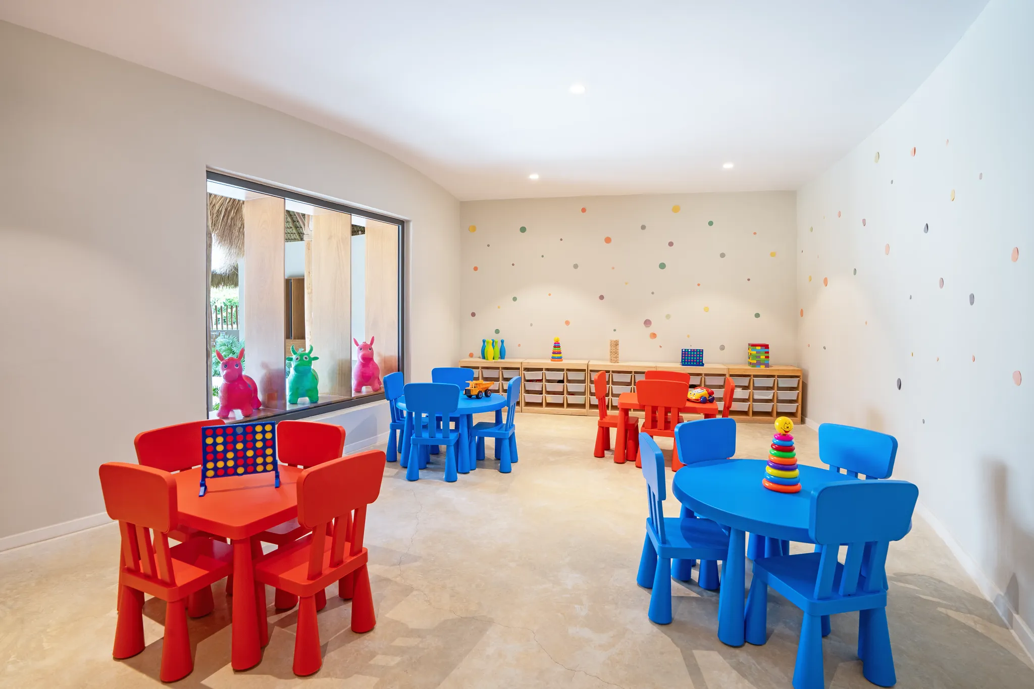 Kids club playroom with colorful tables and toys at Dreams Flora Resort & Spa Punta Cana.