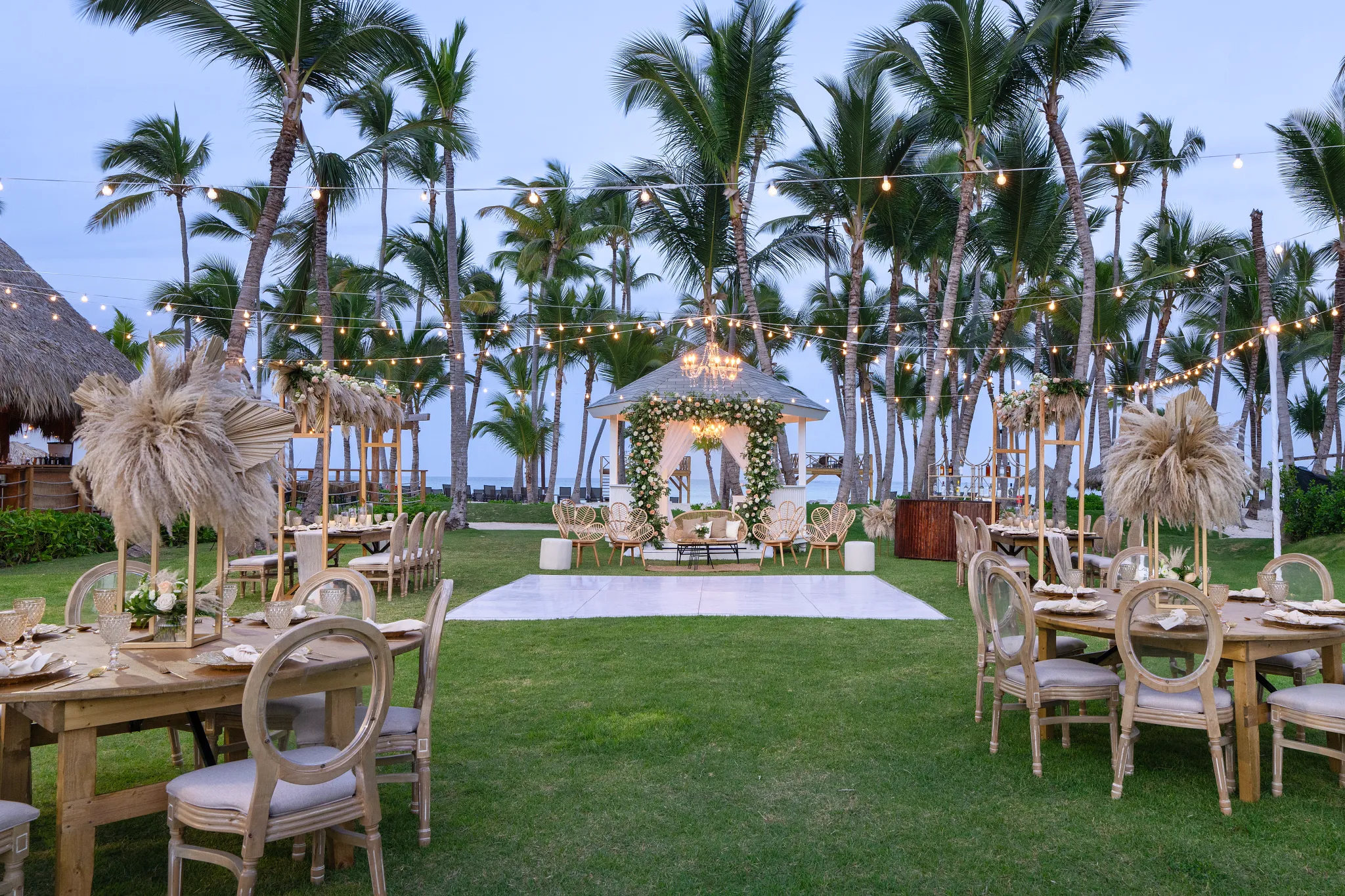 Garden gazebo reception setup with palm trees at Dreams Flora Resort & Spa