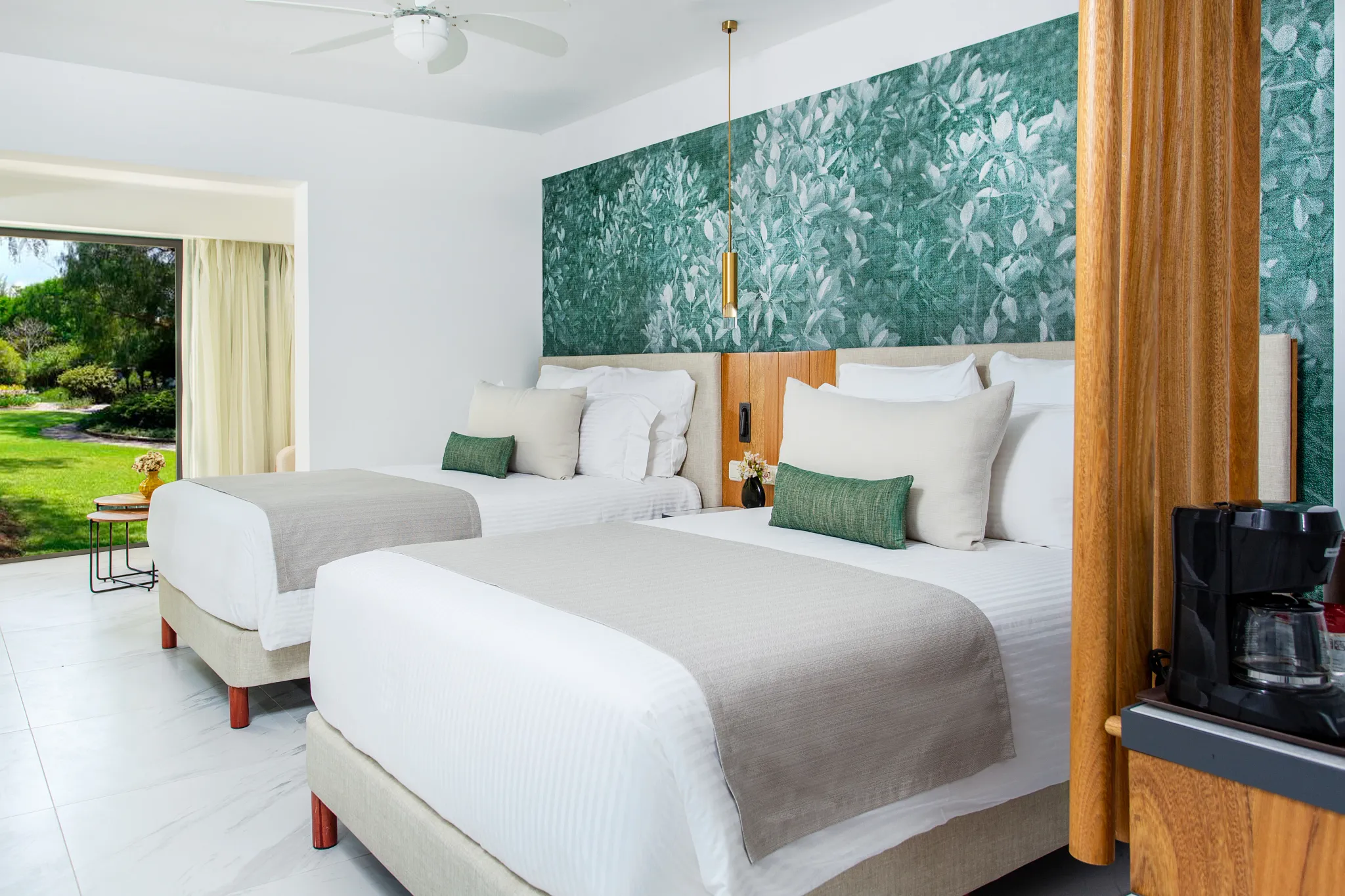 Junior Suite Family Room with two double beds and garden view at Dreams Flora Resort & Spa.