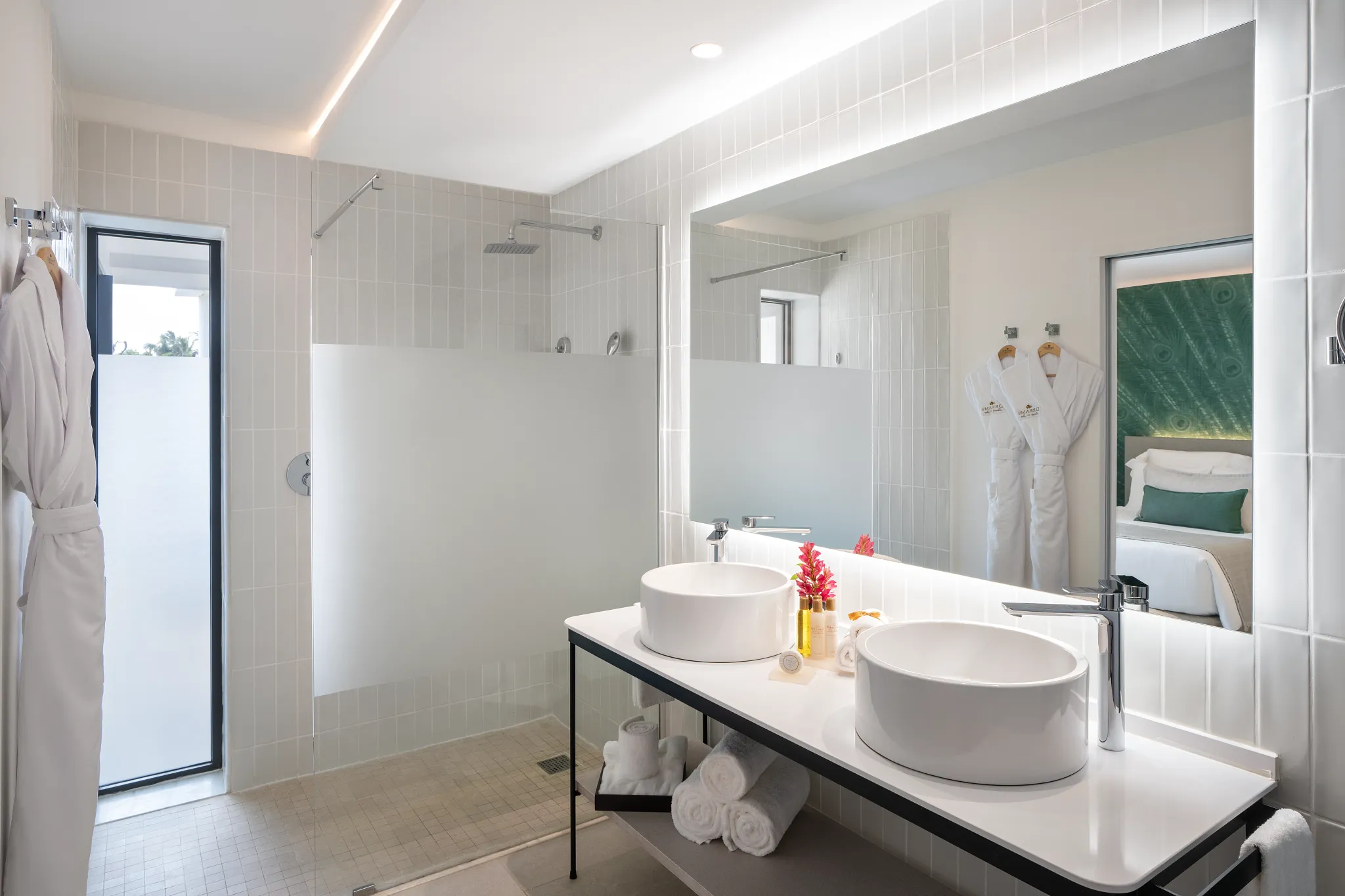 Junior Suite Swim Up bathroom with double sinks and walk-in rain shower at Dreams Flora Resort & Spa.