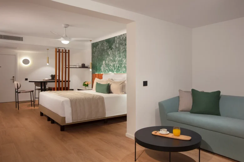 Junior Suite Tropical View with king bed and seating area at Dreams Flora Resort & Spa Punta Cana.