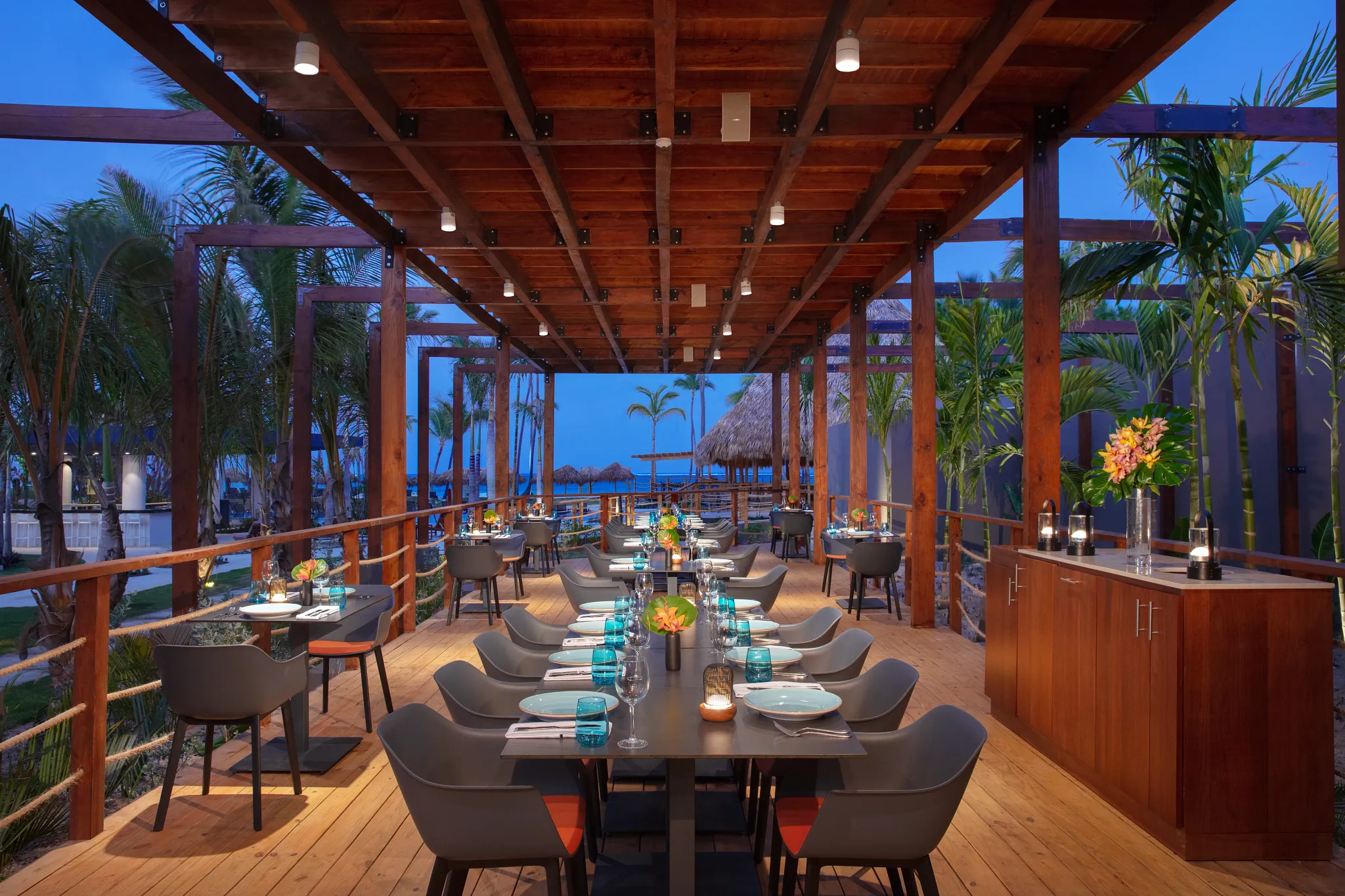 Portofino Italian restaurant at Dreams Flora Resort & Spa featuring open-air terrace dining, ocean views, and elegant evening ambiance.