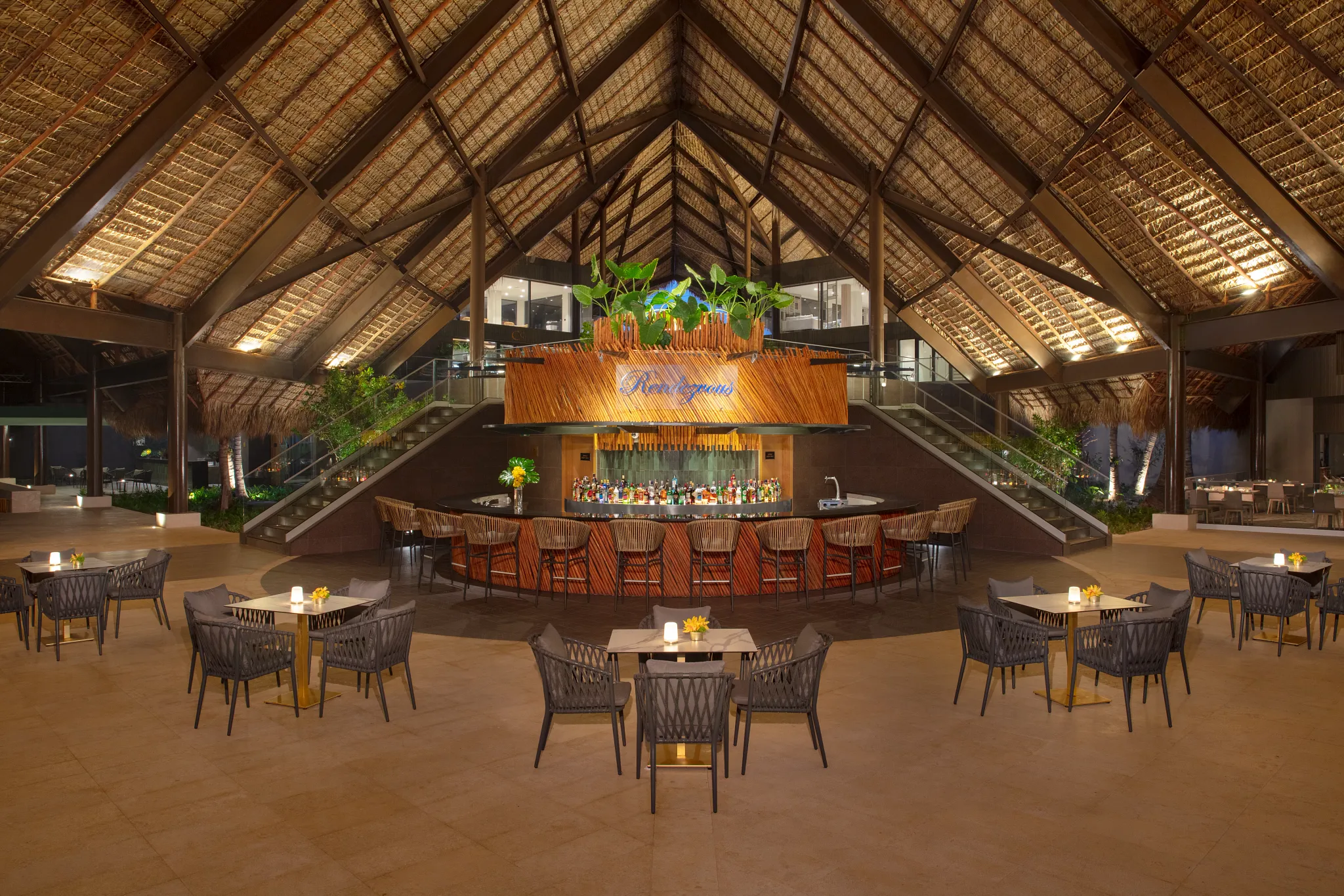 Rendezvous lobby bar at Dreams Flora Resort & Spa featuring a grand open-air design, central bar, and elegant lounge seating.