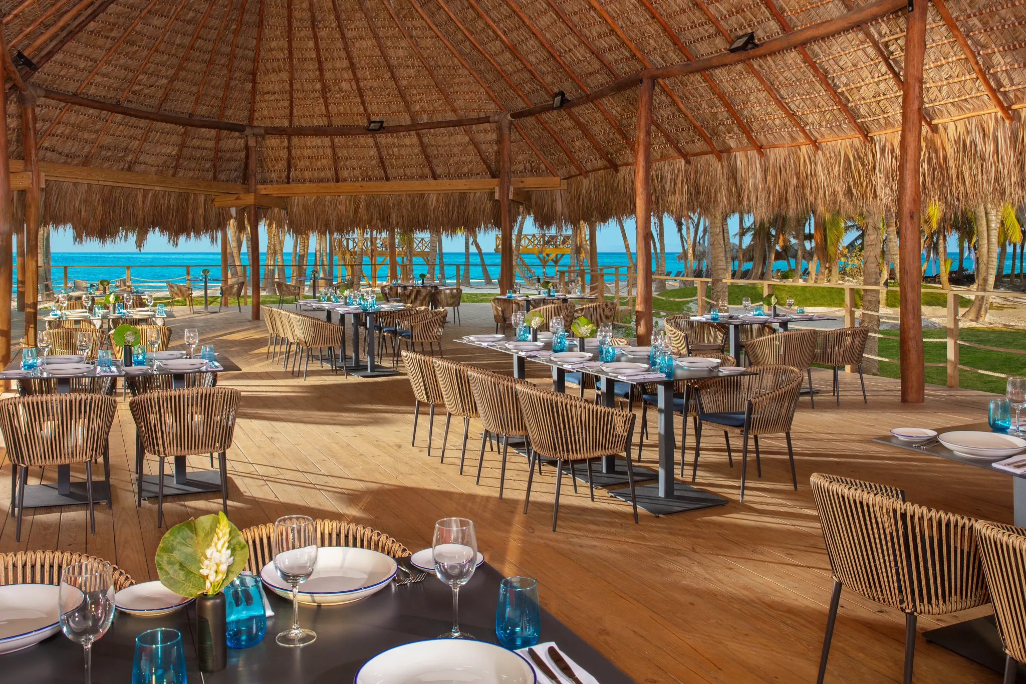 Seaside Grill at Dreams Flora Resort & Spa featuring open-air beachfront dining, thatched roof palapa, and ocean views.