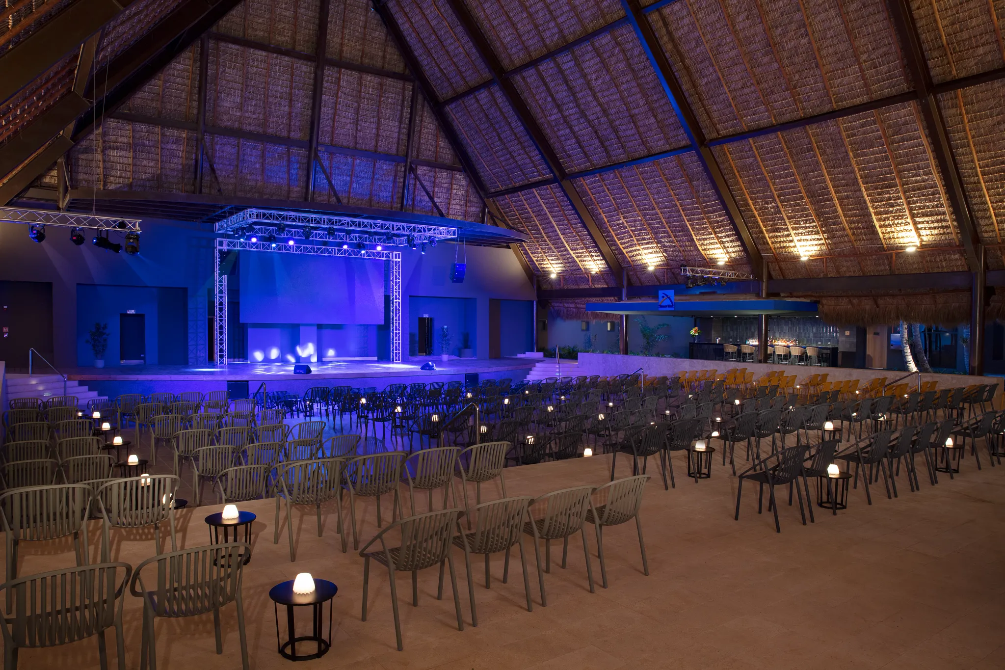 Indoor theater venue setup with stage and seating at Dreams Flora Resort & Spa