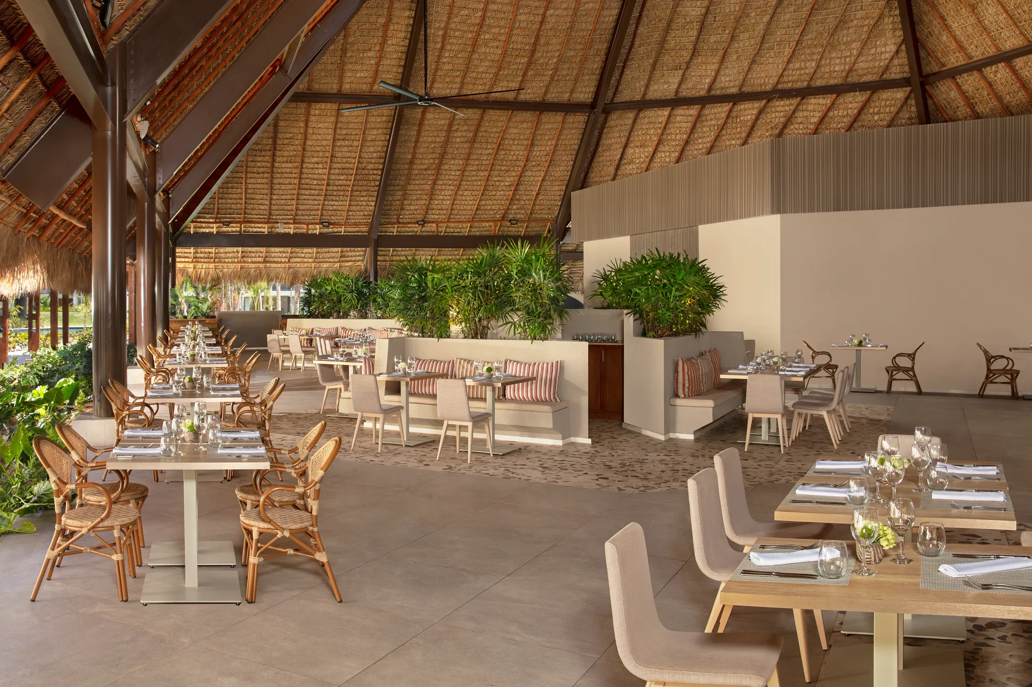 World Café buffet restaurant at Dreams Flora Resort & Spa featuring open-air dining, tropical décor, and international cuisine stations.